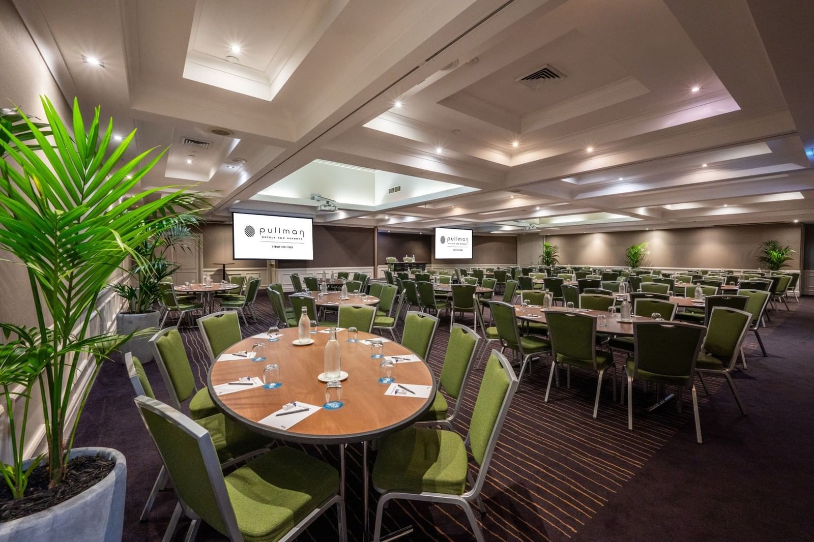 Banquet set-up with projector screens in Ibis Room at Pullman Sydney Hyde Park