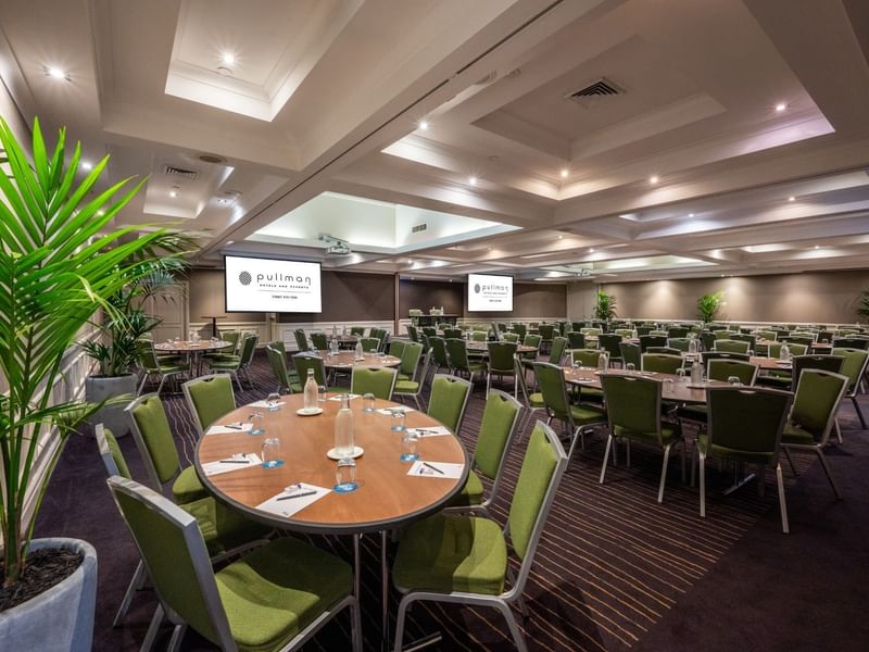 Banquet set-up with projector screens in Ibis Room at Pullman Sydney Hyde Park