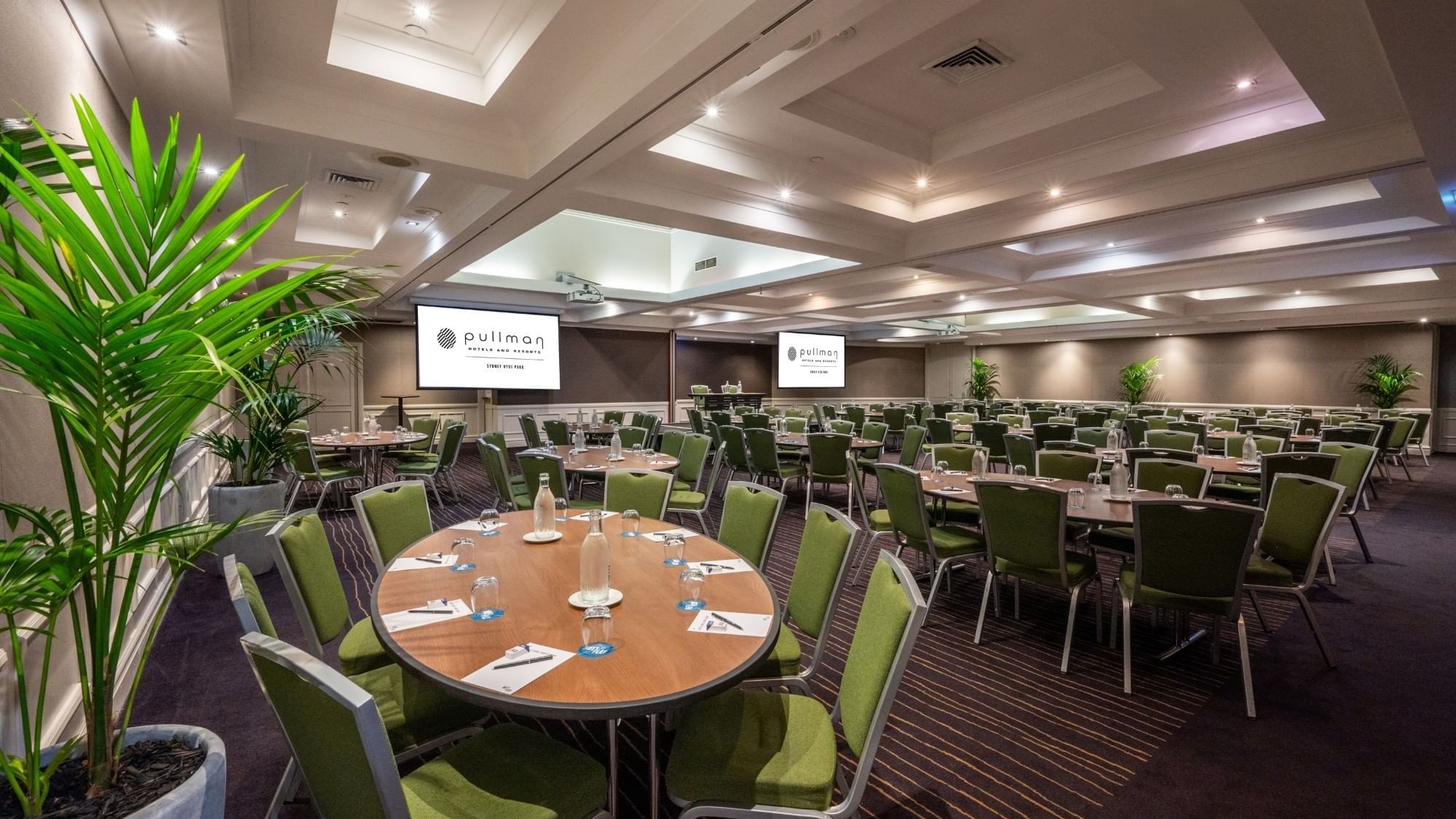 Banquet set-up with projector screens in Ibis Room at Pullman Sydney Hyde Park