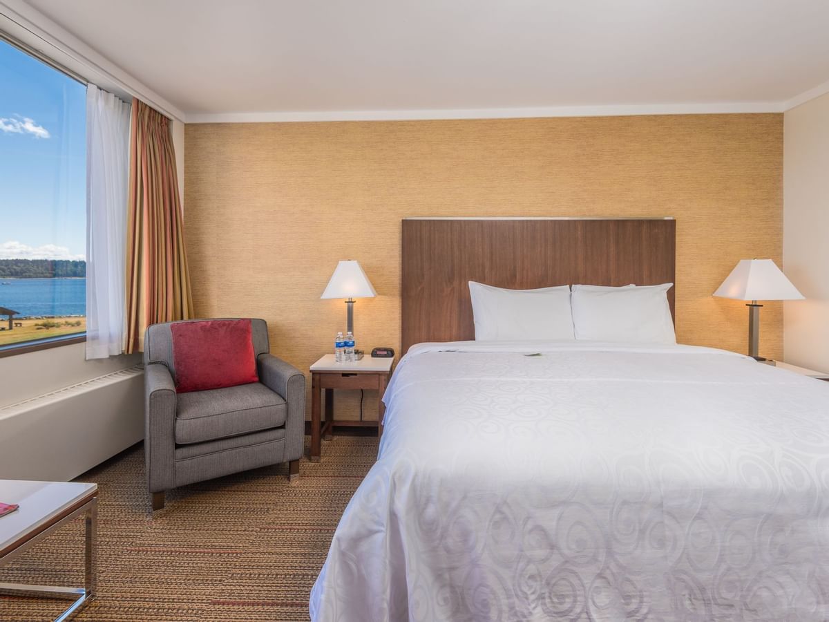 Bed in hotel room with ocean view