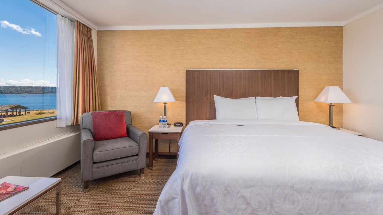 Bed in hotel room with ocean view