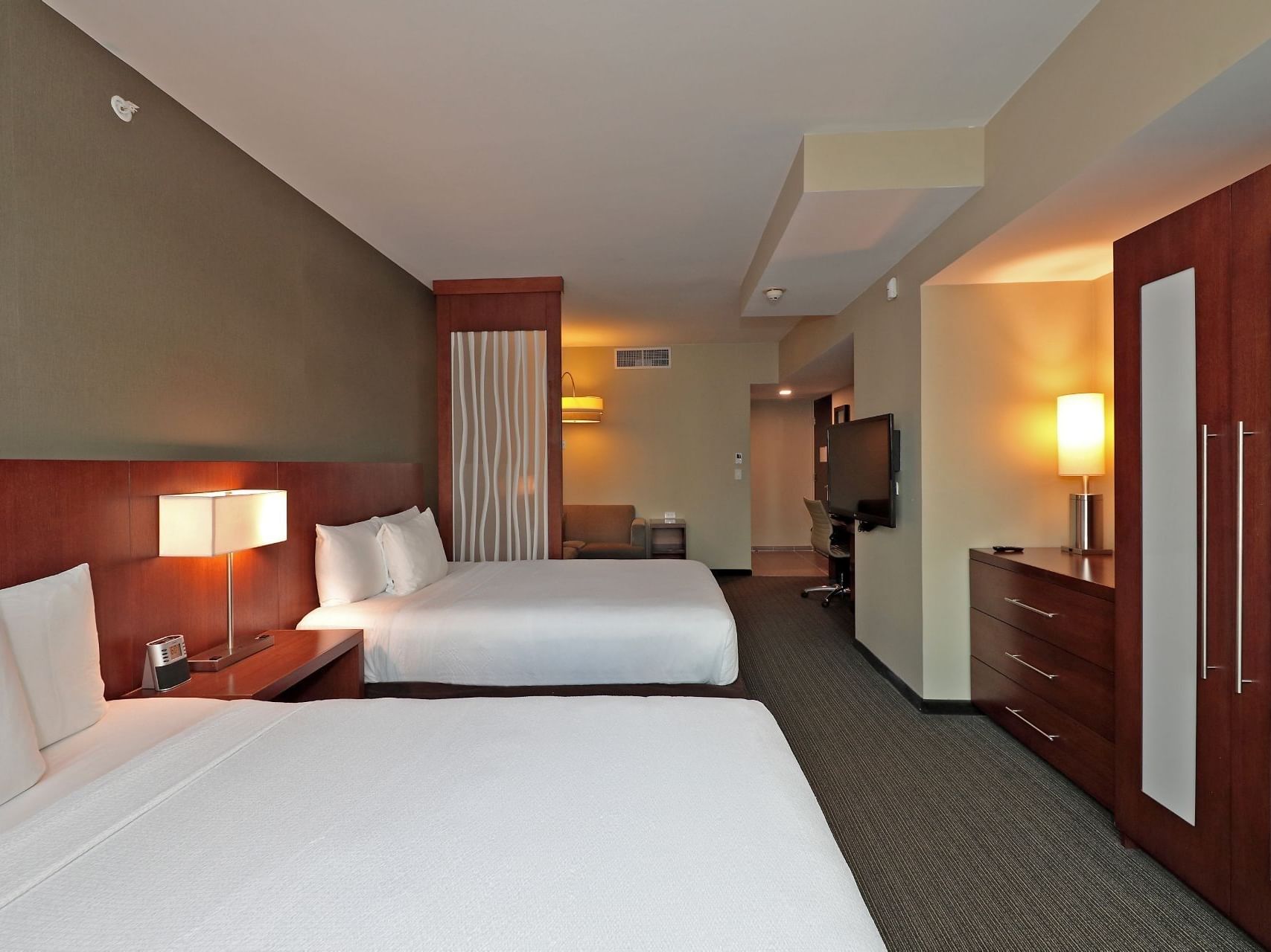 A lit table lamp between two beds in Delux Double at DANN CARLTON MARlNN Place Financial District 