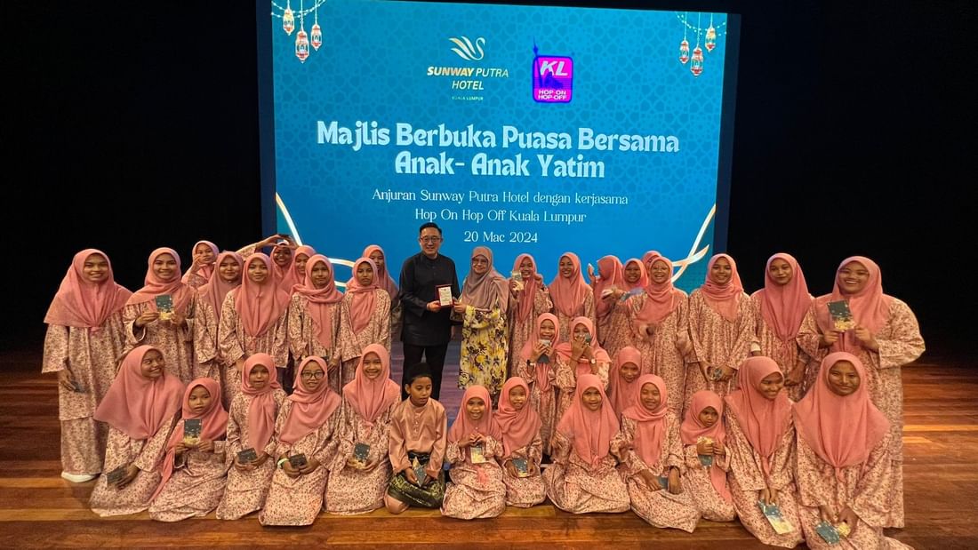 A group of people posing for picture in stage at Sunway Putra Hotel