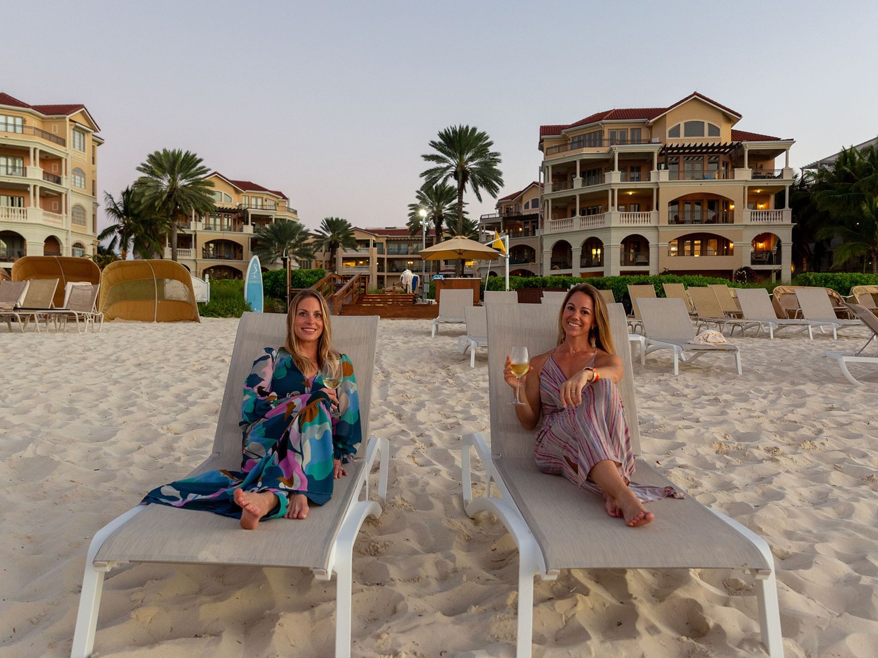 2 ladies on loungers on the beach at The Somerset on Grace Bay