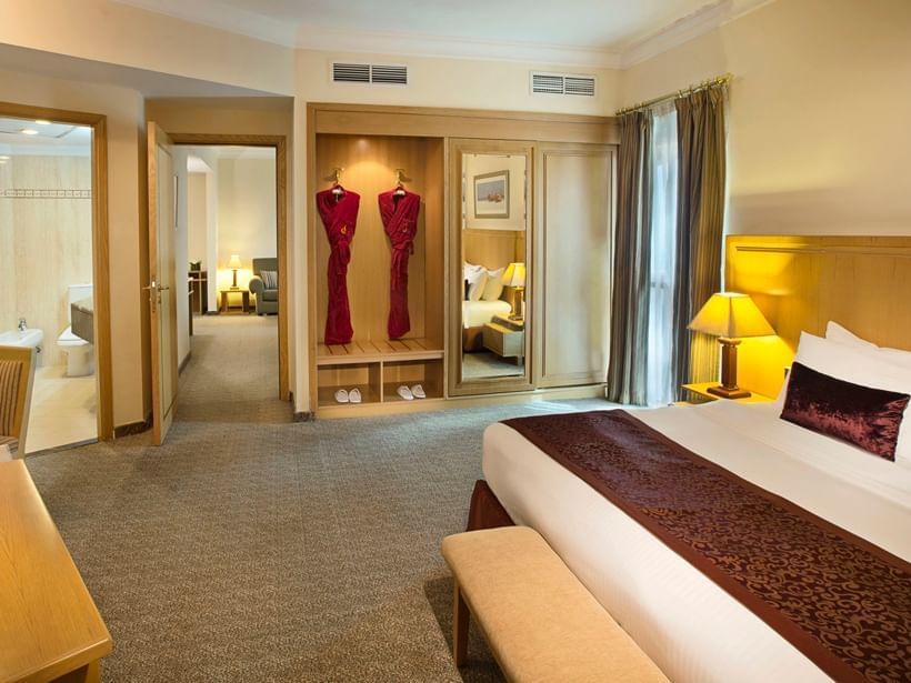 Closet and bed in spacious Seasons Suite at City Seasons Dubai