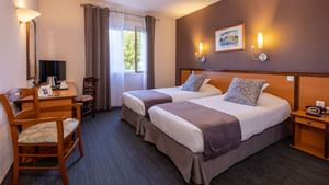 Interior of a bedroom with twin beds at Originals Hotels