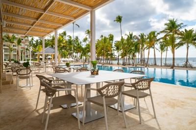 Open dining area by the pool & beach at Club Hemingway