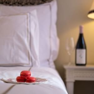 Red macarons & champagne bottles served in a bedroom at The Sparrow Hotel