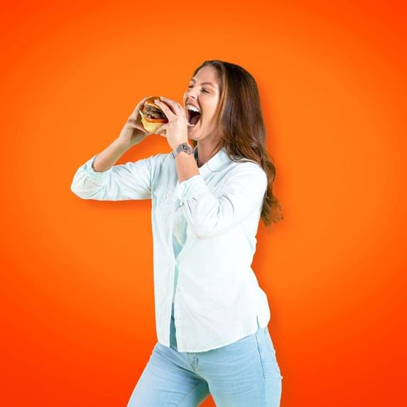 Portrait of a girl eating a burger