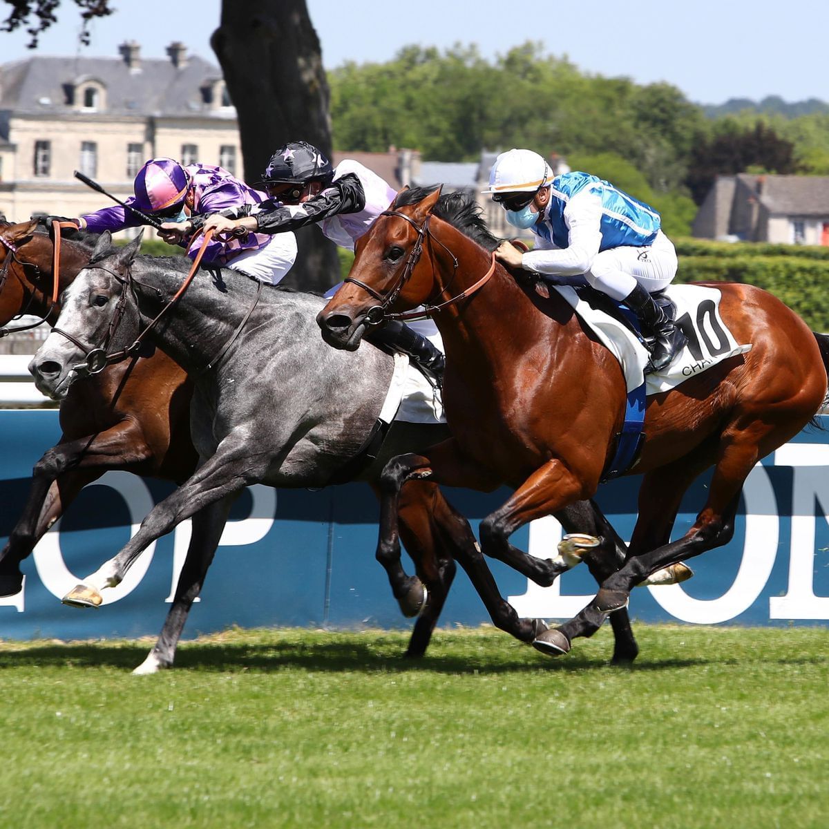 Riders competing on a horserace near The Originals Hotels