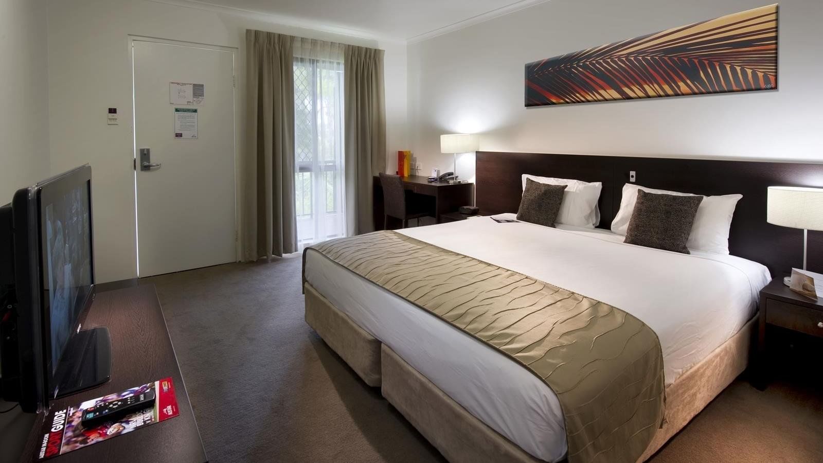 King bed, flat-screen TV, desk area, and modern decor in Superior Room at Mercure Hotel Townsville