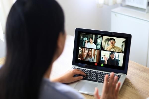 Women having a virtual meeting with team