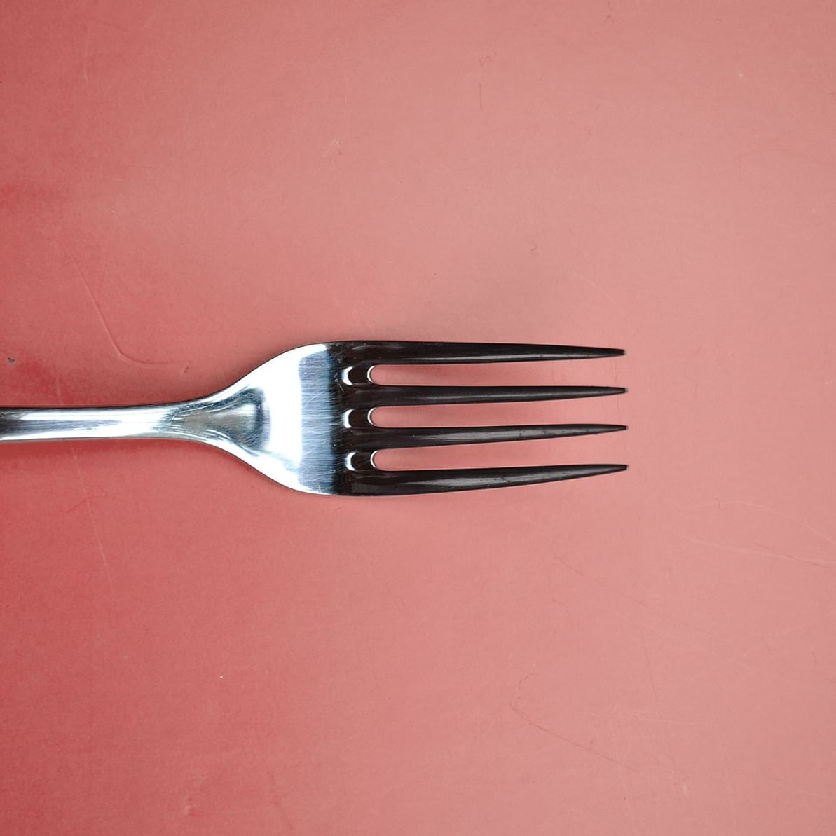 Closeup of a fork on pink background at Plymouth Hotel