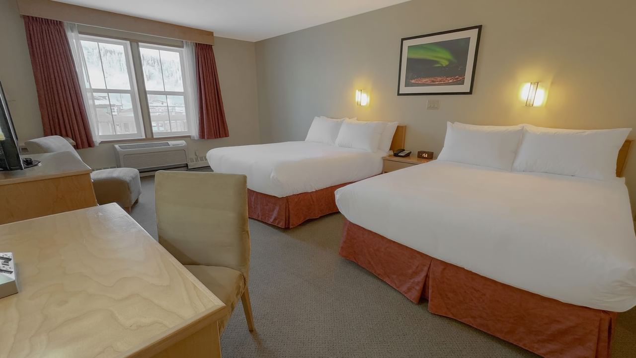 two queen beds with a work desk