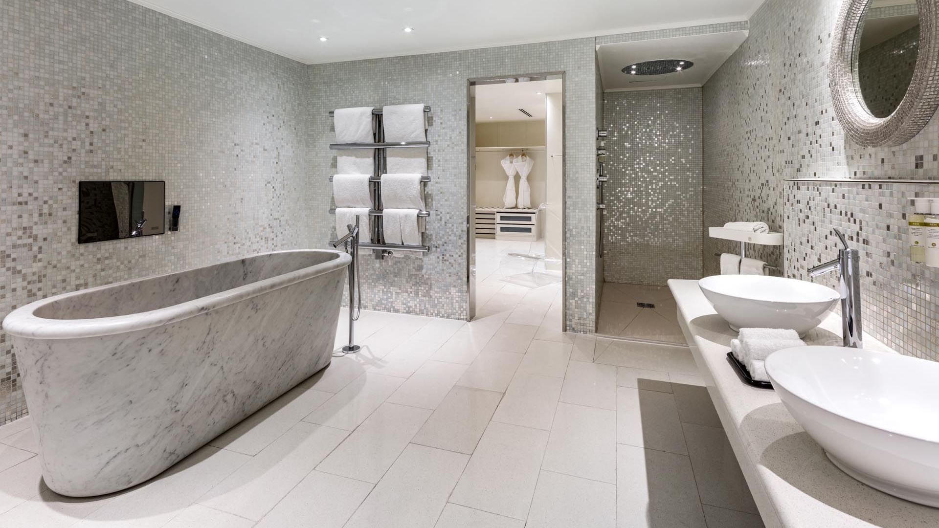 Elegant bathroom in The Penthouse Suite at The May Fair Hotel London featuring a marble bathtub and dual sinks