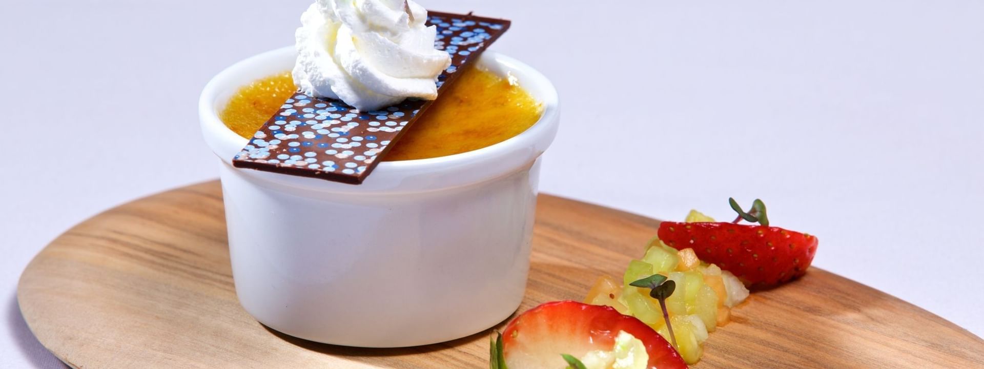 Custard dessert with fruit garnish under whipped cream in Edgewater Grill at Warwick Paradise Island Bahamas