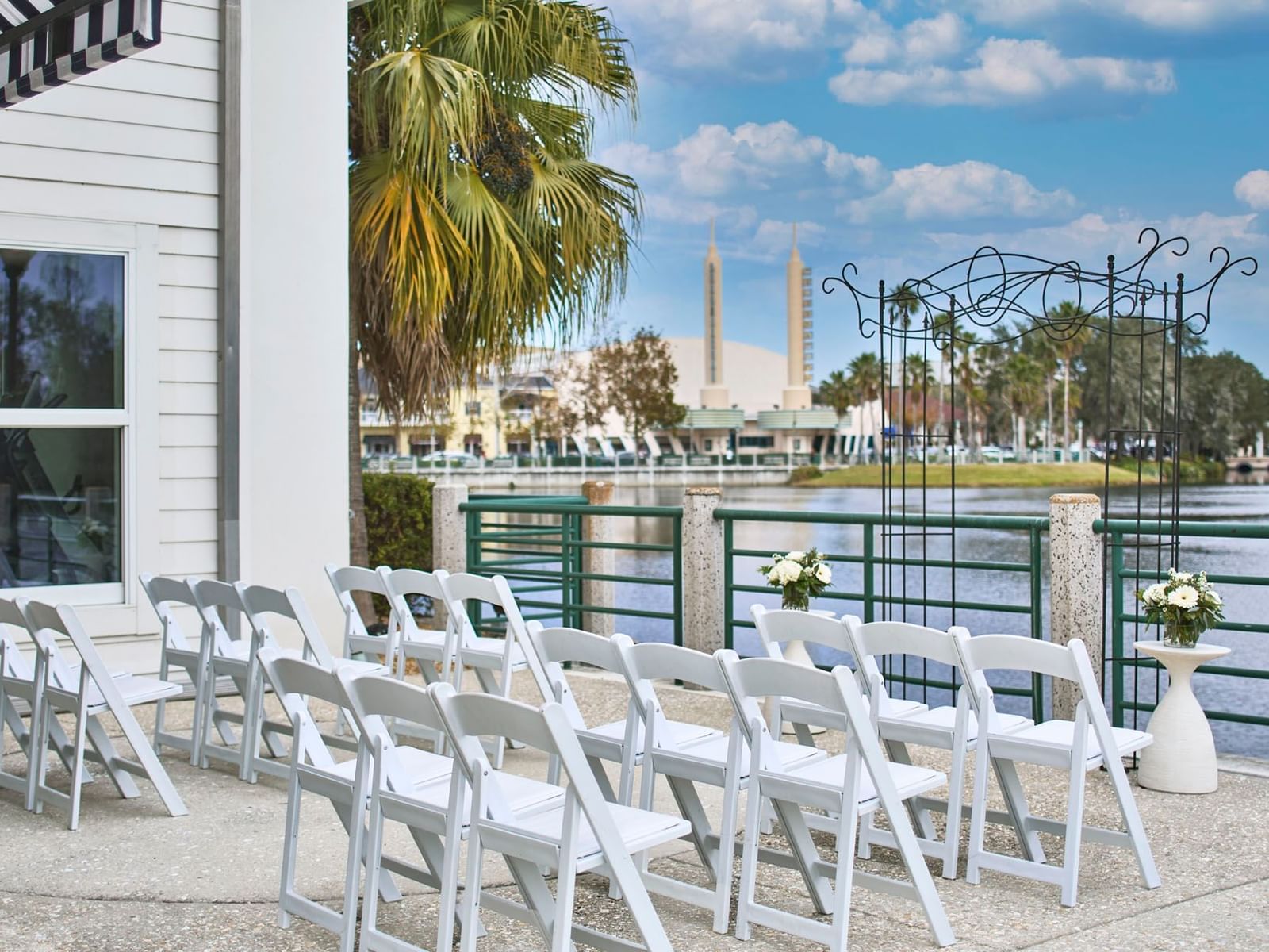 Lake Rianhard Terrace at the Inn at Celebration, with white chairs set up facing an arch by the waterfront