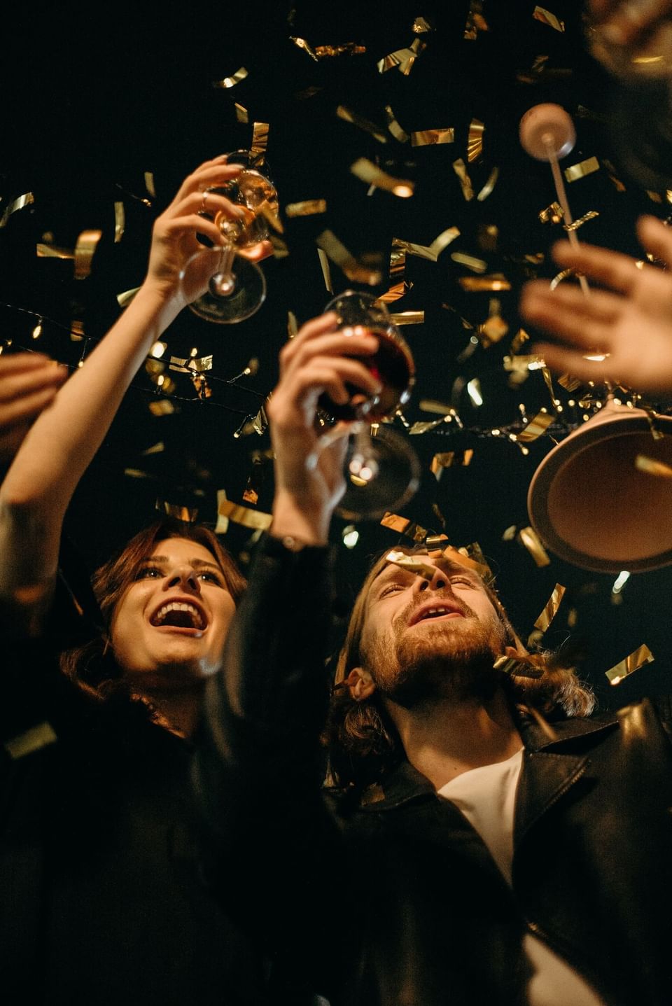 A couple celebrating an event holding wine glasses at Portico84