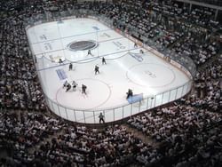 Aerial view of hockey game in Idaho Central Arena surrounded by crowd near Hotel 43