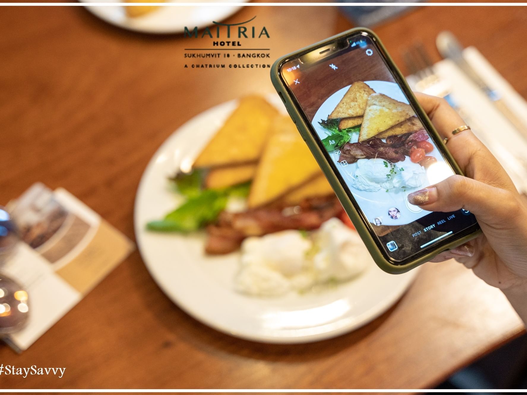 Customer photographing a meal served at Maitria Sukhumvit 18