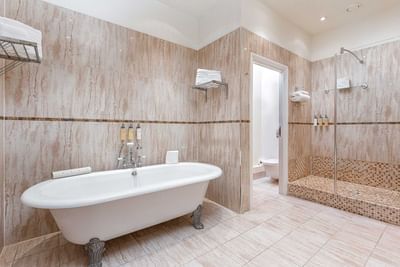 Interior view of a Bathroom with shower area and bathtub at Orsett Hall Hotel