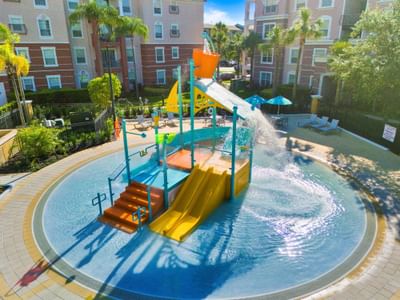 Kids pool with slides and splash pad at Vista Cay Resort By Millenium