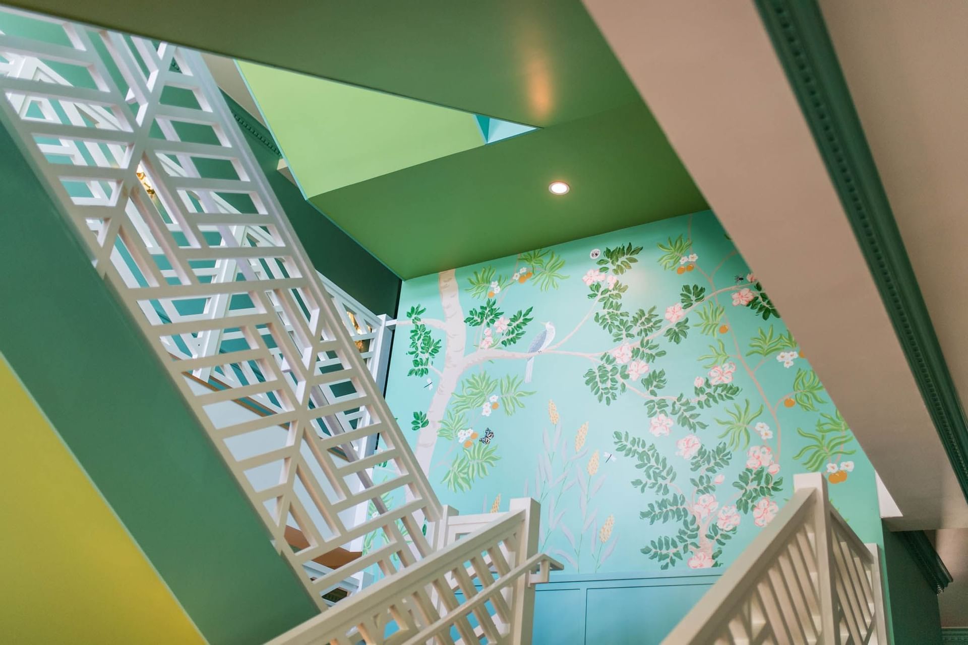 green stairwell with tree painting
