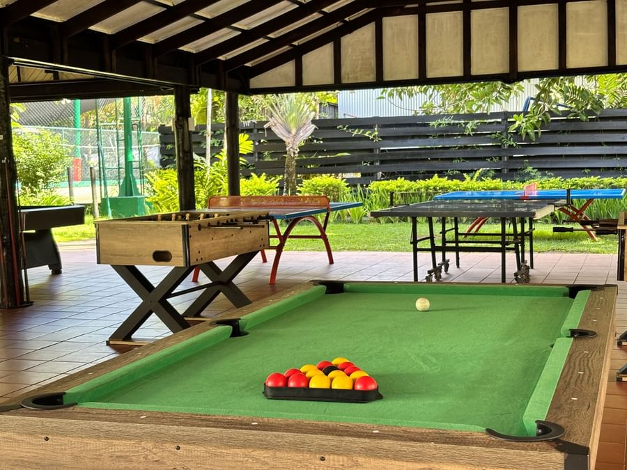 A billiards table with balls and a white ball at Warwick Fiji Resort and Spa.