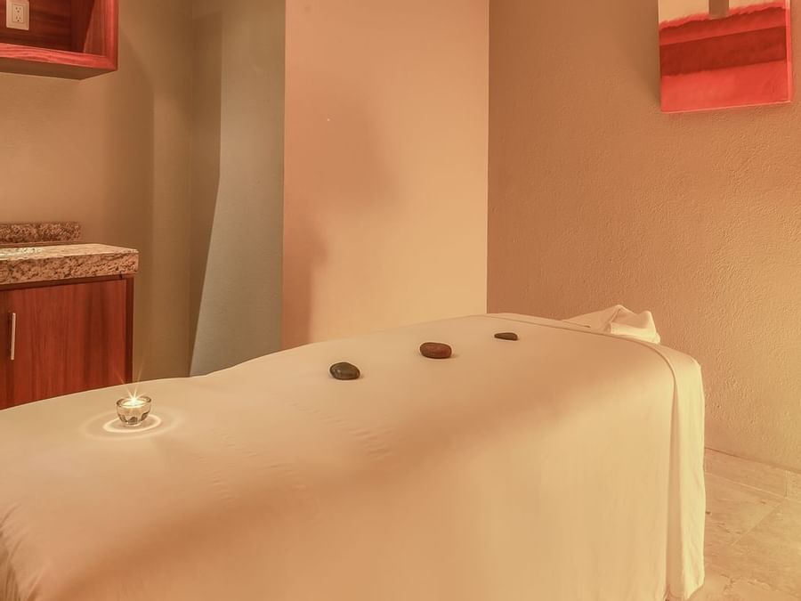 Spa bed with stone in a spa room at FA Hotels & Resorts