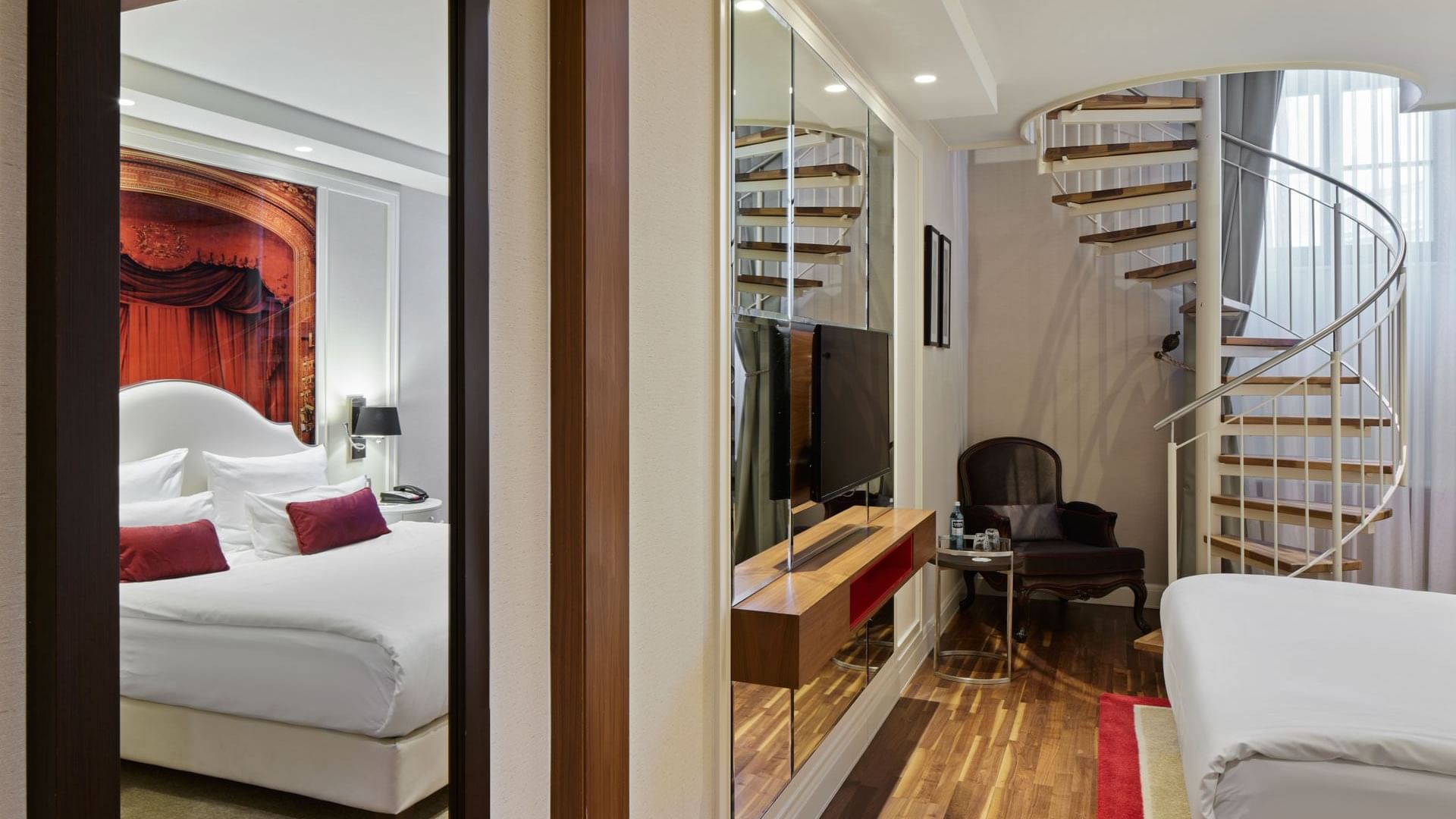 Spiral staircase by the king bed in Junior Duplex Suite at Titanic Gendarmenmarkt Berlin