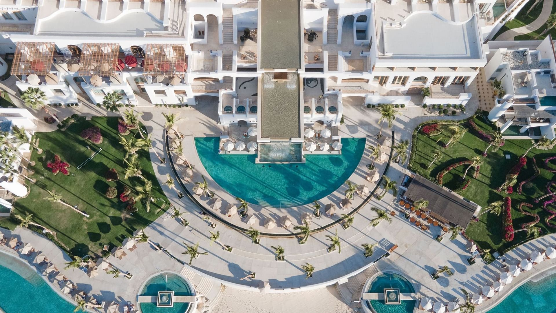 Aerial view of the luxurious Mayia Exclusive Resort & Spa with its large pool surrounded by lush greenery.