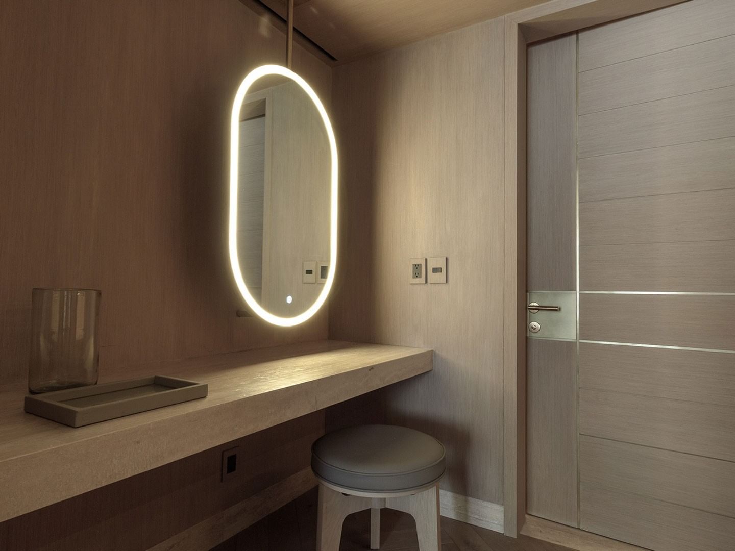 King Superior Viceroys Suite vanity area featuring a glowing mirror and a wooden desk at Camino Real Polanco Mexico