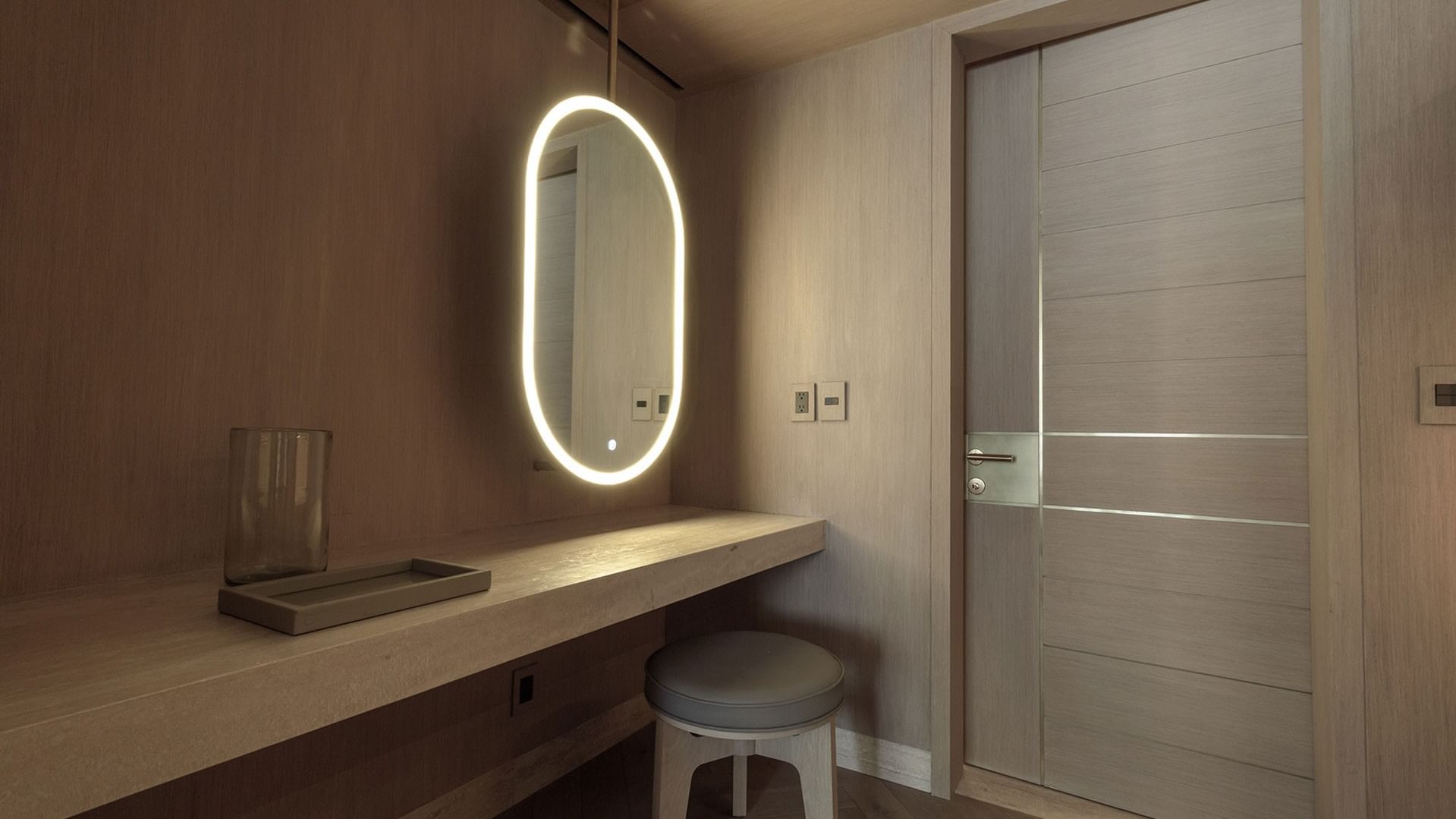 King Superior Viceroys Suite vanity area featuring a glowing mirror and a wooden desk at Camino Real Polanco Mexico