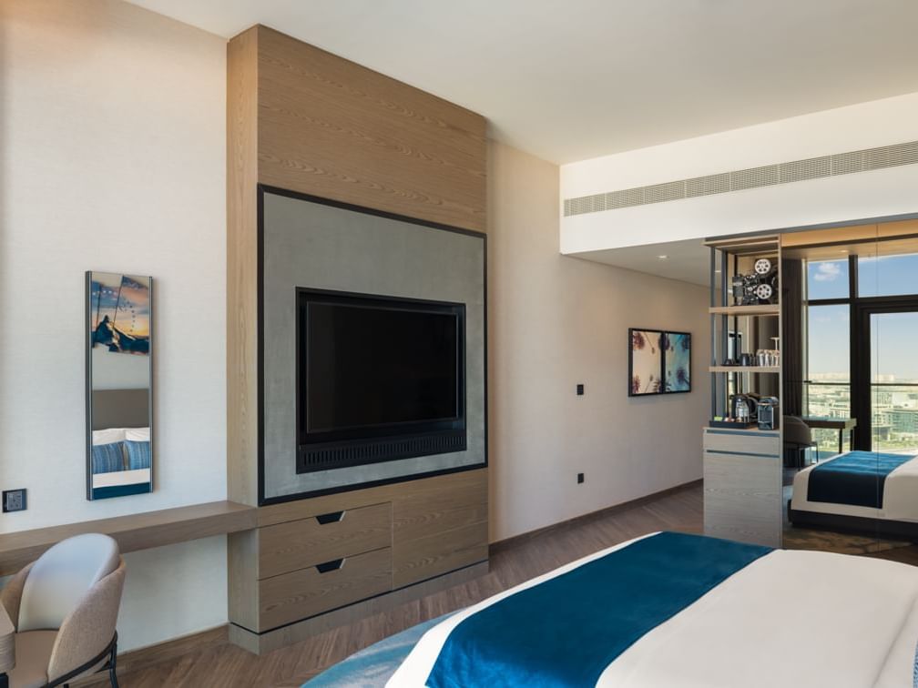 Comfy bed, wooden cabinet with a TV in Scene Room Coastal at Paramount Hotel Midtown