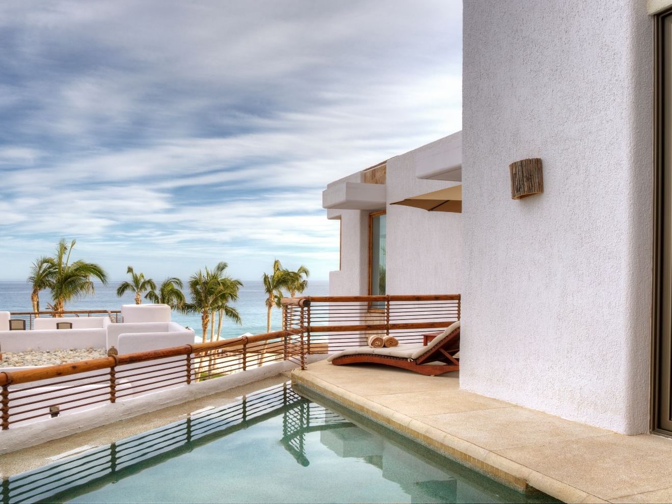 Lounge chair by a pool in a Master Suite at Marquis Los Cabos