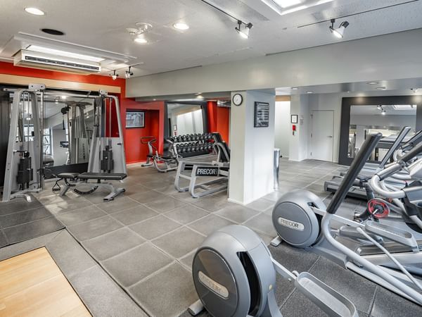 Fitness center featuring cardio equipment and weights
