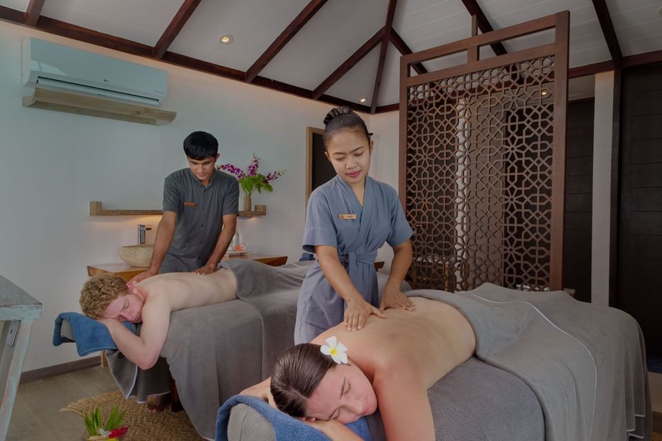 Couple having a body treatment in the spa at Grand Park Kodhipparu, Maldives