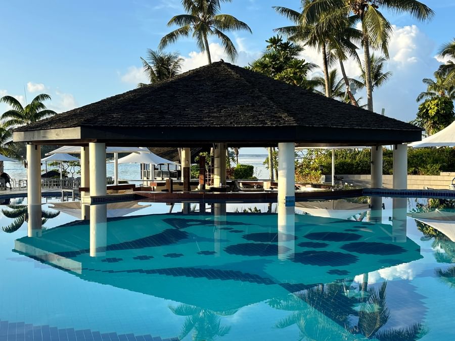 Swimming pool with thatched gazebo and ocean view at Warwick Le Lagon Vanuatu.