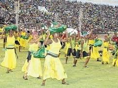 Dancers carrying green bundles on their heads performing in the stadium near Jamaica Pegasus Hotel