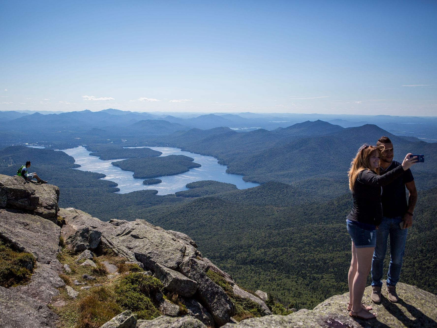 A couple taking photographs in Whiteface Mountain near High Peaks Resort