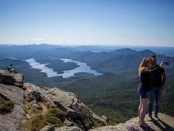 A couple taking photographs in Whiteface Mountain near High Peaks Resort