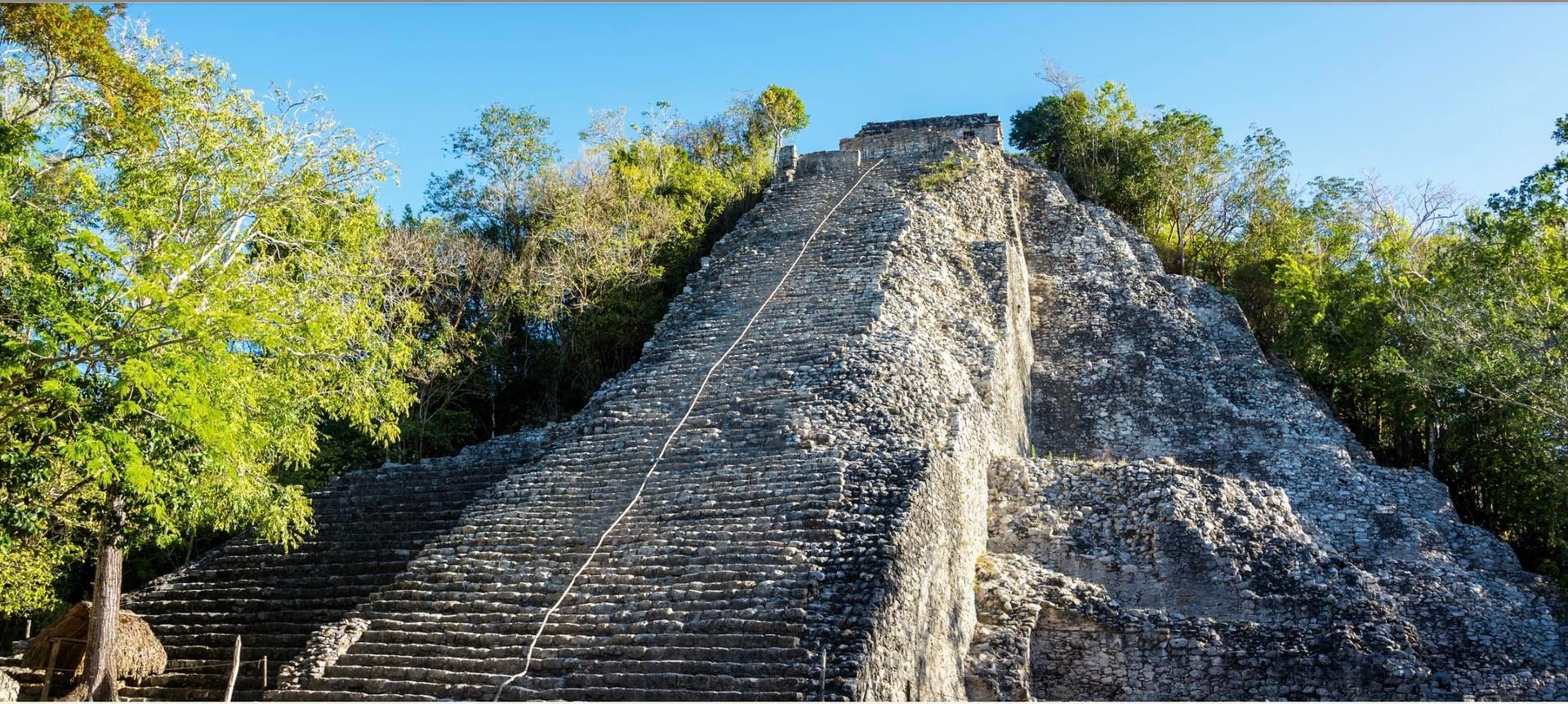 The Nohoch Mul pyramid at Coba surrounded by jungle near Tulum.