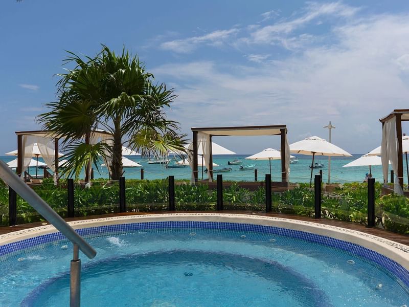 Outdoor pool with cabanas at The Reef Coco Beach