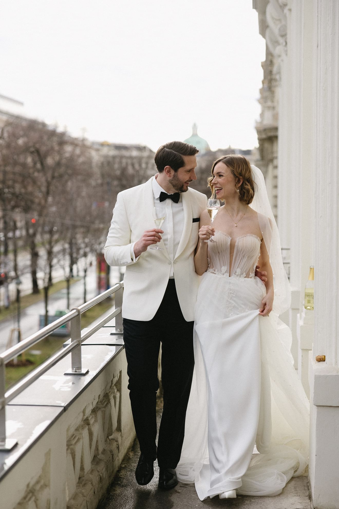 Newlyweds on balcony overlooking cityscape at Almanac Palais Vienna