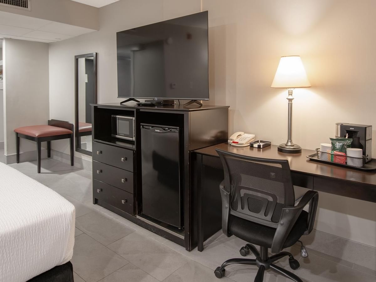 Accessible room with queen bed, desk, chair, and TV.