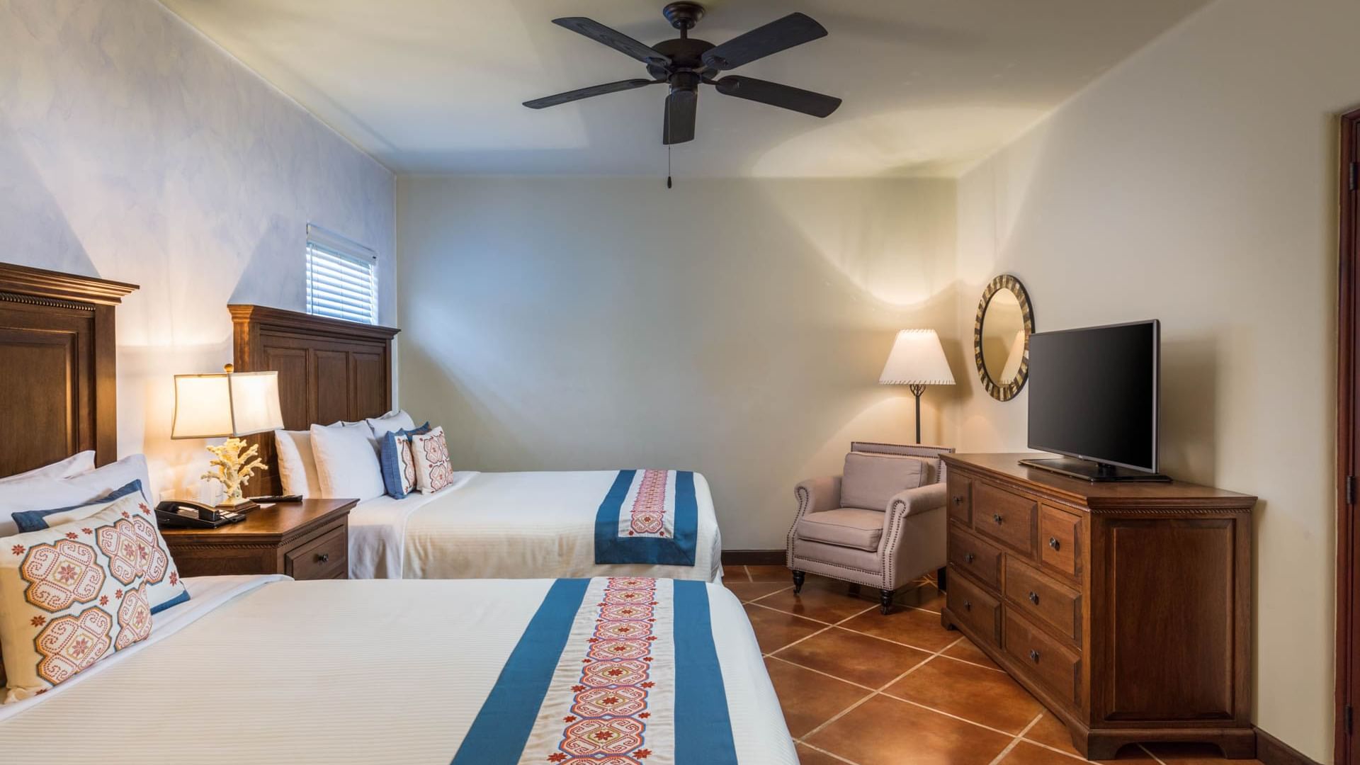 Luxury Studio with two queen beds stylish decor and flat screen TV, creating a relaxing stay at Hacienda Del Mar Los Cabos.