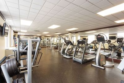Fitness centre with various exercise machines, including treadmills and weight stations at Sandman Hotel & Suites Winnipeg Airport