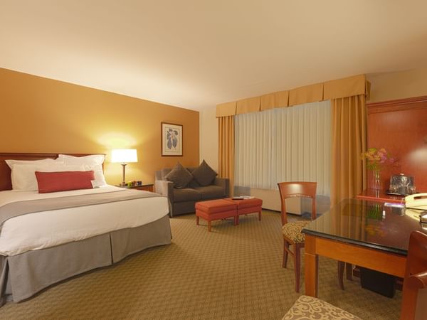 King bed, sofa and desk in hotel room