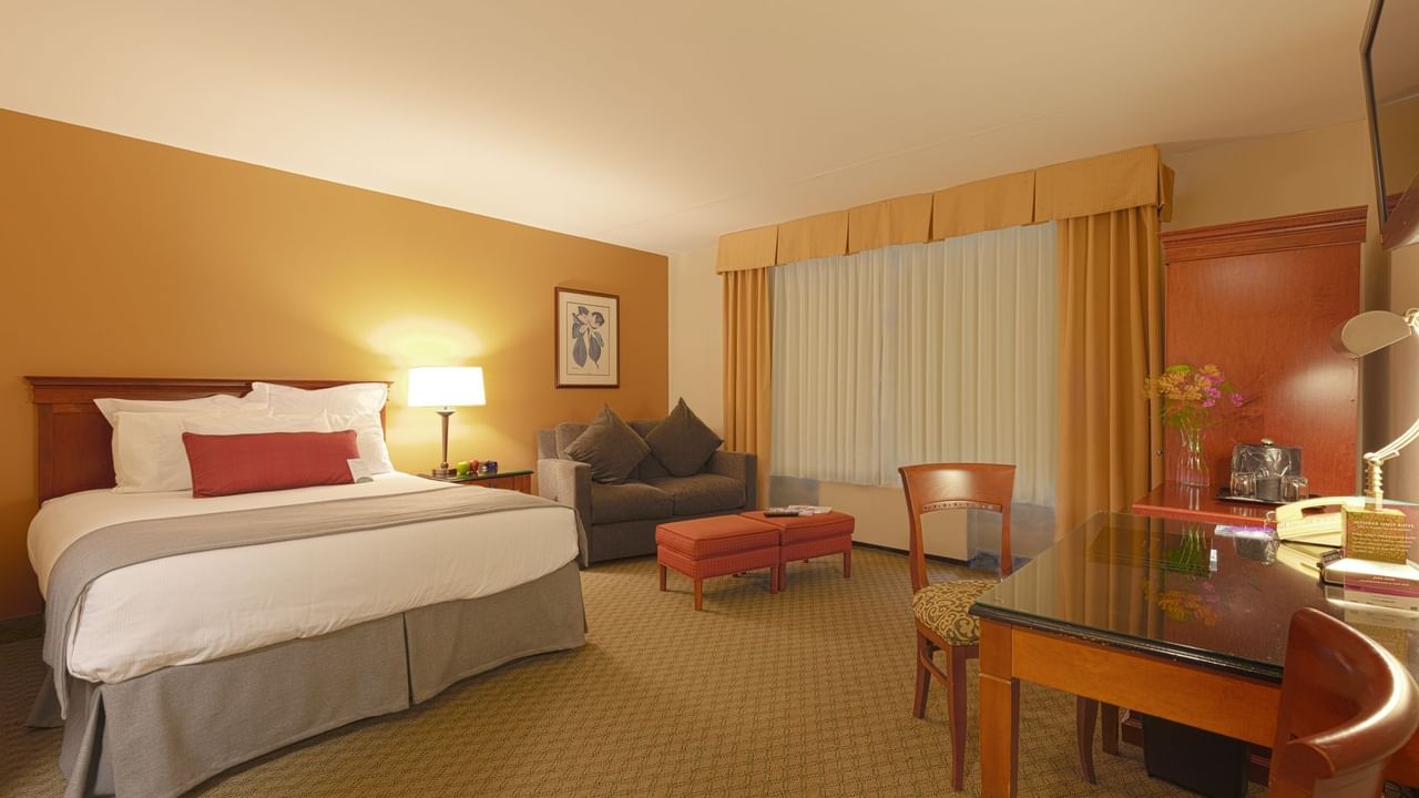 King bed, sofa and desk in hotel room