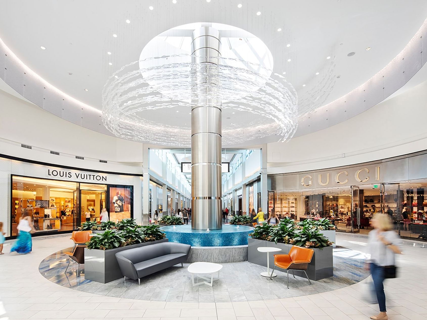 Spacious lounge area with large chandelier inside the Town Center Mall near Ocean Lodge Boca Raton